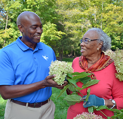 A Visiting Angels caregiver comforting an elderly woman with Alzheimer's, highlighting compassionate support in a peaceful home setting.