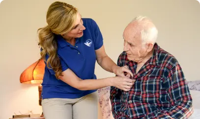 A Visiting Angels caregiver engaging with an elderly man outdoors, highlighting the warmth of in-home care services.