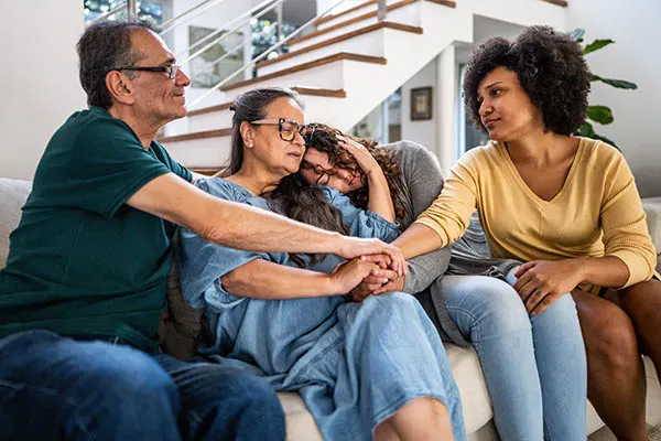 Family gathers to console each other on sofa